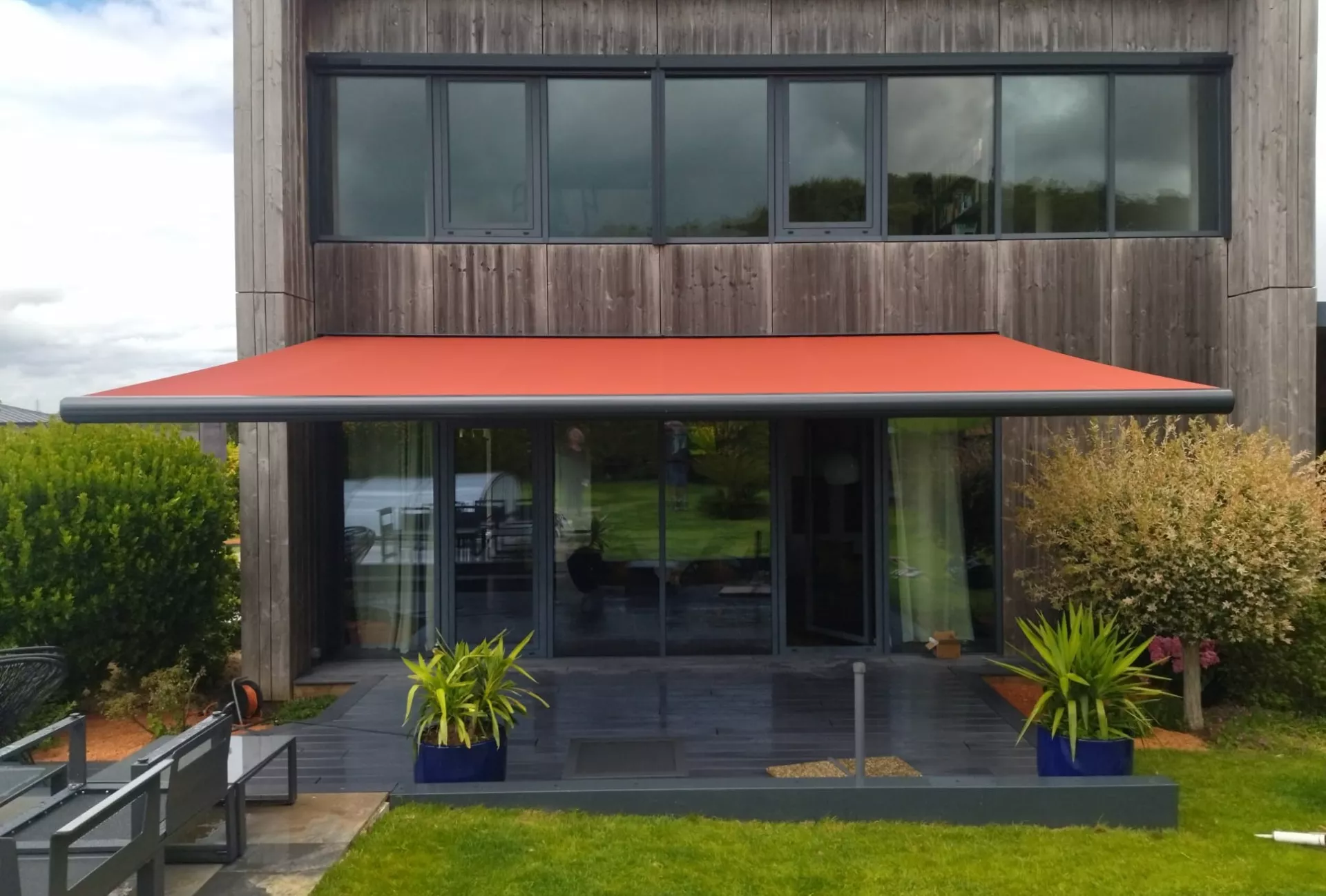 Store banne à coffre motorisé de 6m de large toile châtaigne  bras et coffre gris anthracite à Plédran